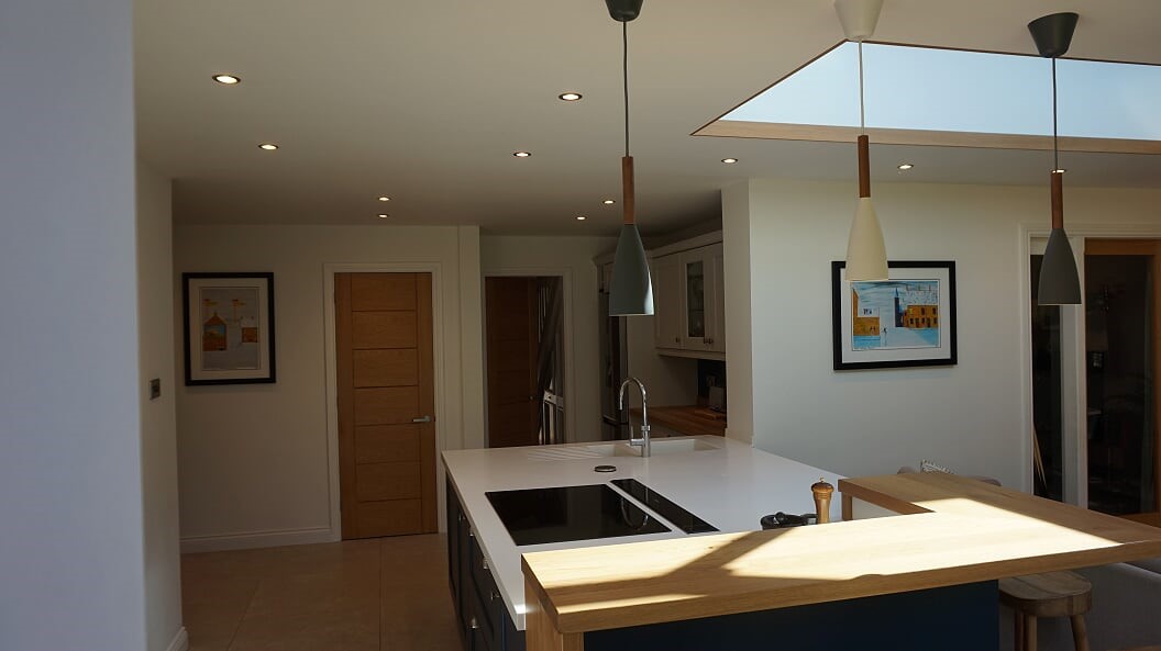 LG Hi Macs Apline white solid surface top with raised solid oak bar area