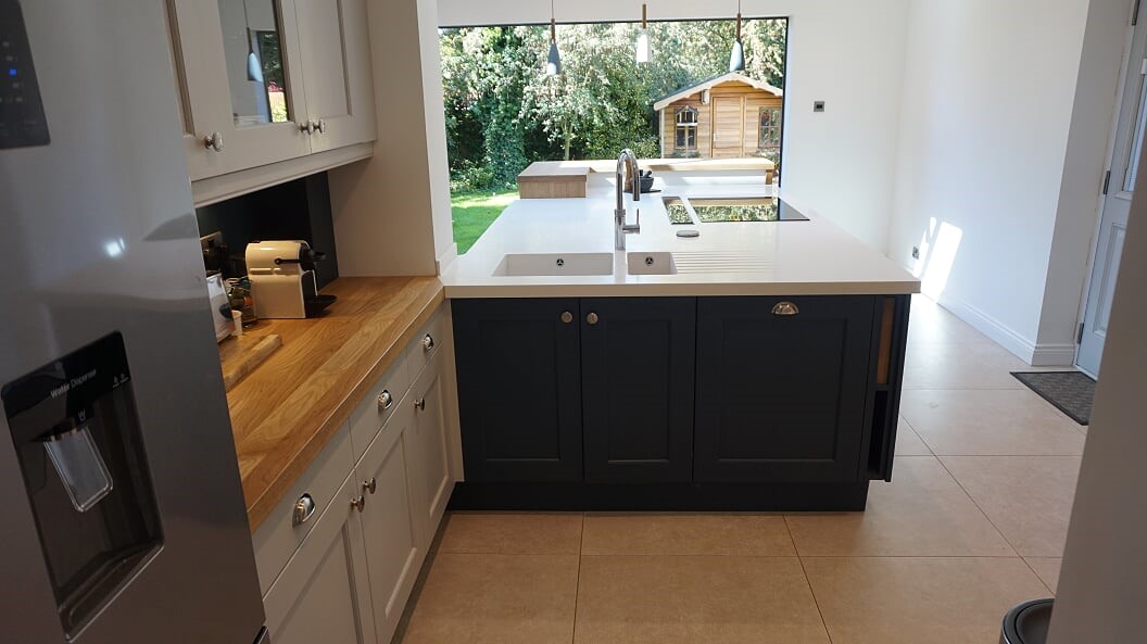 LG Hi Macs Apline white solid surface top with raised solid oak bar area